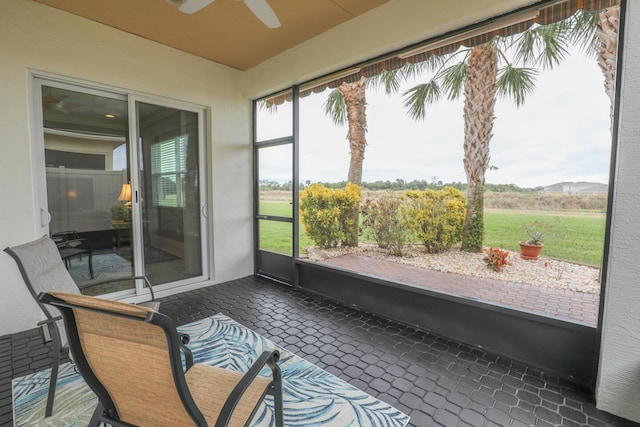 sunroom / solarium featuring ceiling fan