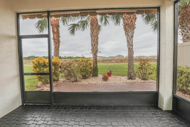 doorway to outside featuring dark tile patterned floors