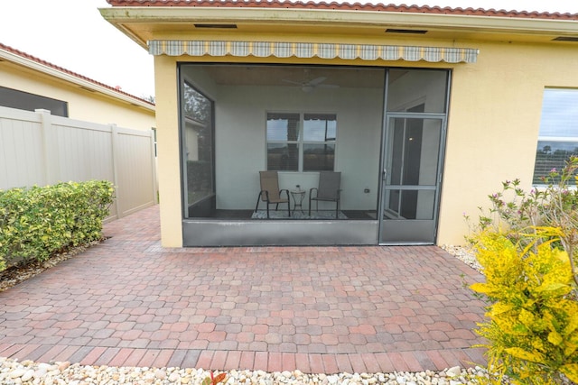 rear view of property with a patio area, fence, and a sunroom