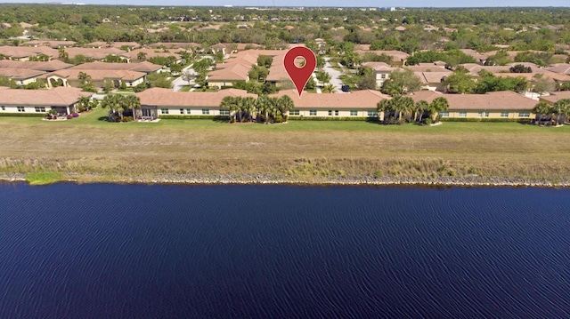 birds eye view of property featuring a water view and a residential view