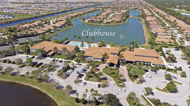 drone / aerial view featuring a water view and a residential view