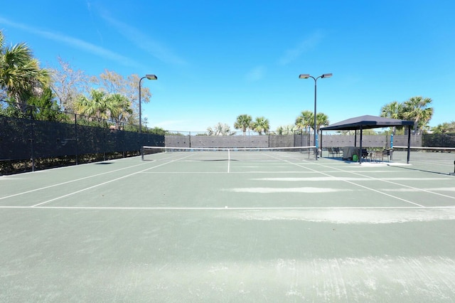 view of sport court featuring fence