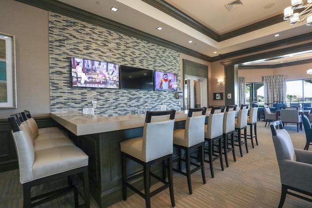 bar featuring visible vents, crown molding, carpet, wet bar, and a notable chandelier