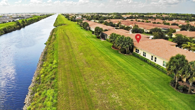 drone / aerial view featuring a residential view and a water view