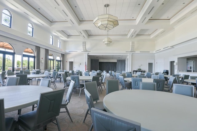 dining area with coffered ceiling, carpet floors, and a high ceiling