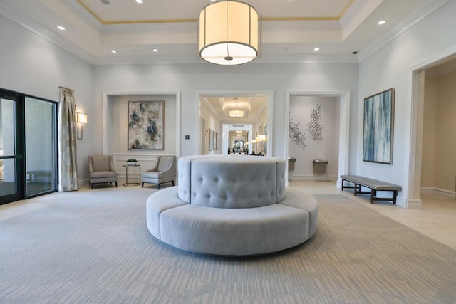 sitting room featuring recessed lighting, a tray ceiling, and ornamental molding