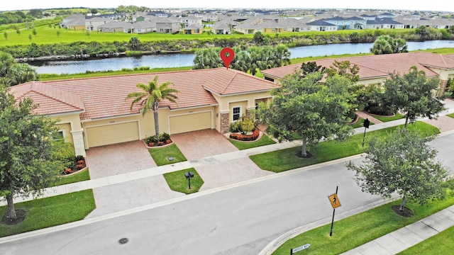 birds eye view of property with a residential view and a water view