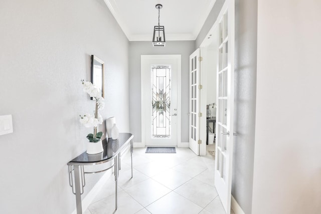 foyer entrance featuring crown molding and light tile patterned flooring