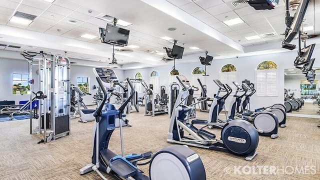 gym featuring a drop ceiling and light colored carpet