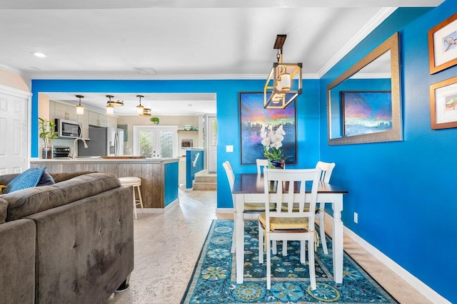 dining area featuring sink, french doors, and ornamental molding