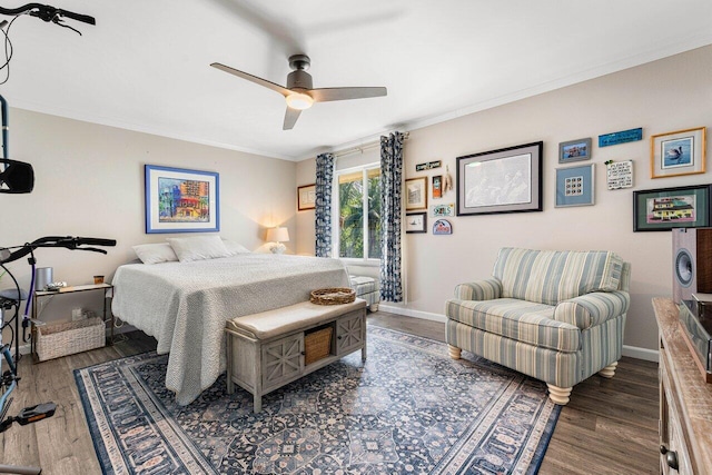 bedroom featuring ceiling fan, dark hardwood / wood-style flooring, and crown molding