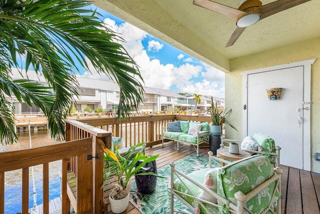 wooden balcony with ceiling fan and a deck