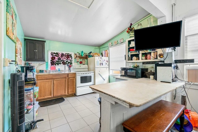 kitchen featuring lofted ceiling, white appliances, a kitchen breakfast bar, light tile patterned floors, and kitchen peninsula