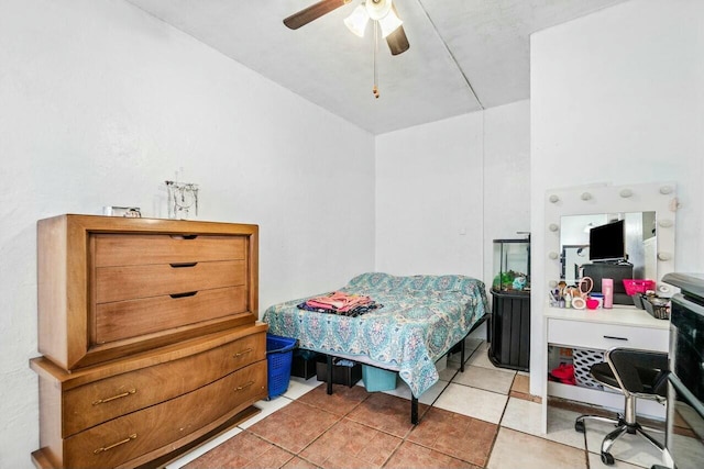 tiled bedroom featuring ceiling fan