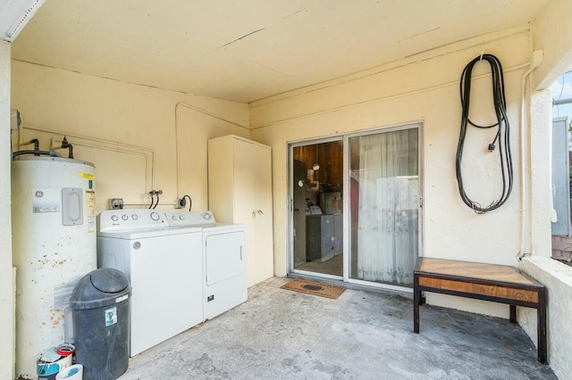 clothes washing area with washer and clothes dryer and water heater