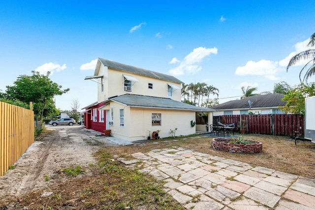 rear view of house featuring a patio