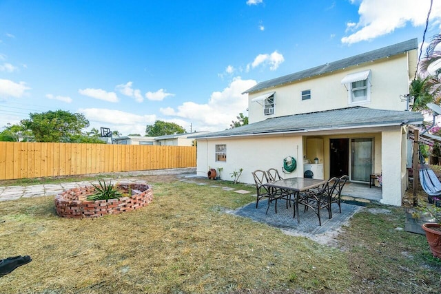 back of house with a patio area and a yard