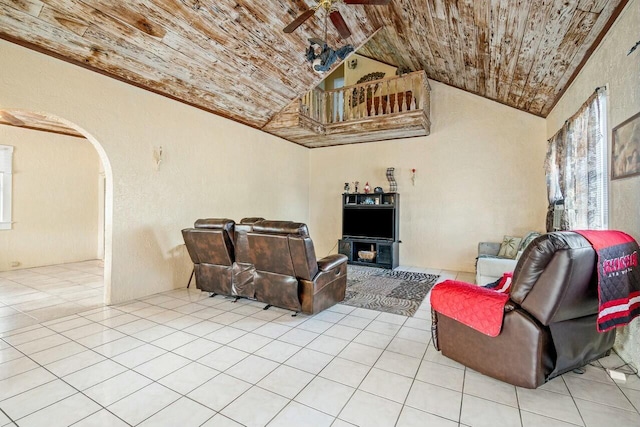 living room featuring lofted ceiling, ceiling fan, wood ceiling, and light tile patterned floors