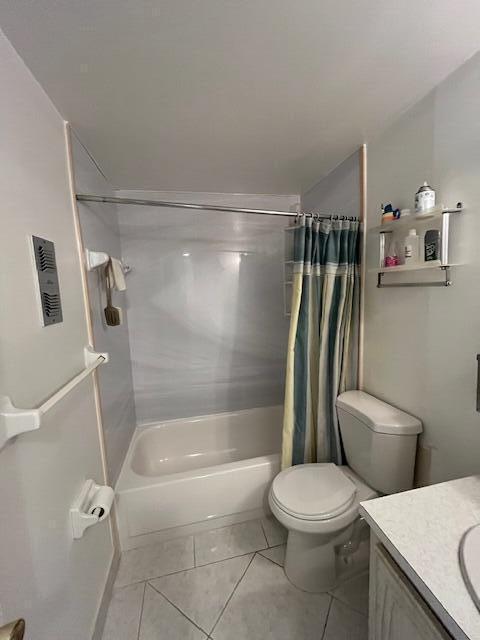 full bathroom with tile patterned flooring, vanity, toilet, and shower / tub combo with curtain