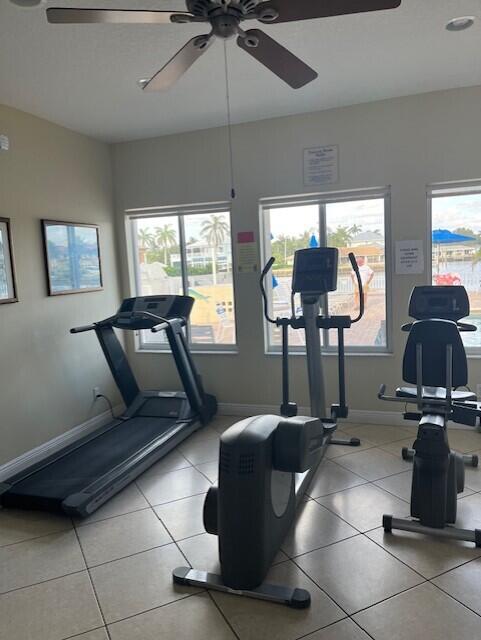 exercise area featuring ceiling fan and a healthy amount of sunlight