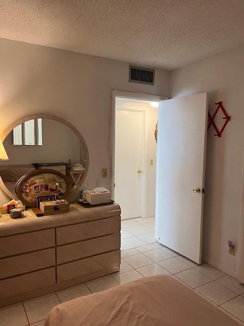 unfurnished bedroom with light tile patterned floors and a textured ceiling