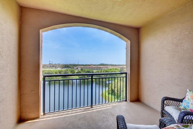 balcony featuring a water view