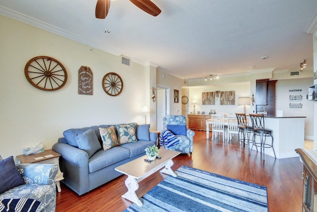 living room with dark hardwood / wood-style flooring and ornamental molding