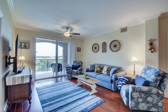 living room featuring dark hardwood / wood-style floors, ceiling fan, and crown molding