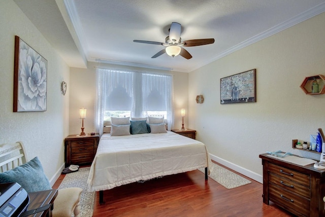 bedroom featuring ceiling fan, dark hardwood / wood-style flooring, and ornamental molding