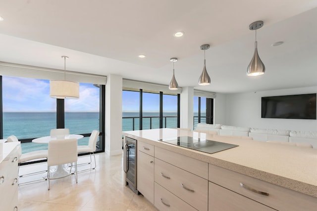 kitchen with wine cooler, black electric cooktop, light tile patterned floors, and decorative light fixtures