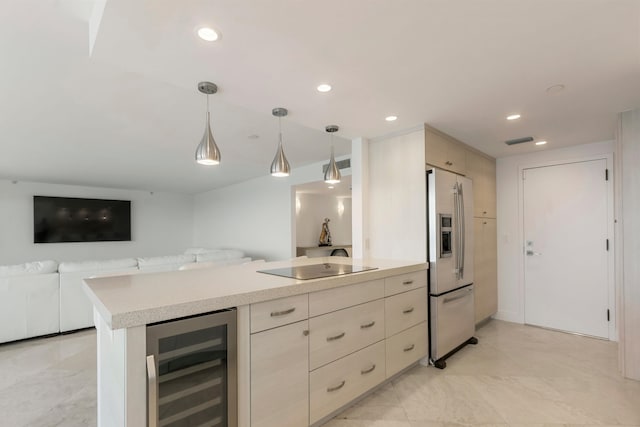 kitchen featuring black electric cooktop, stainless steel fridge, hanging light fixtures, and beverage cooler