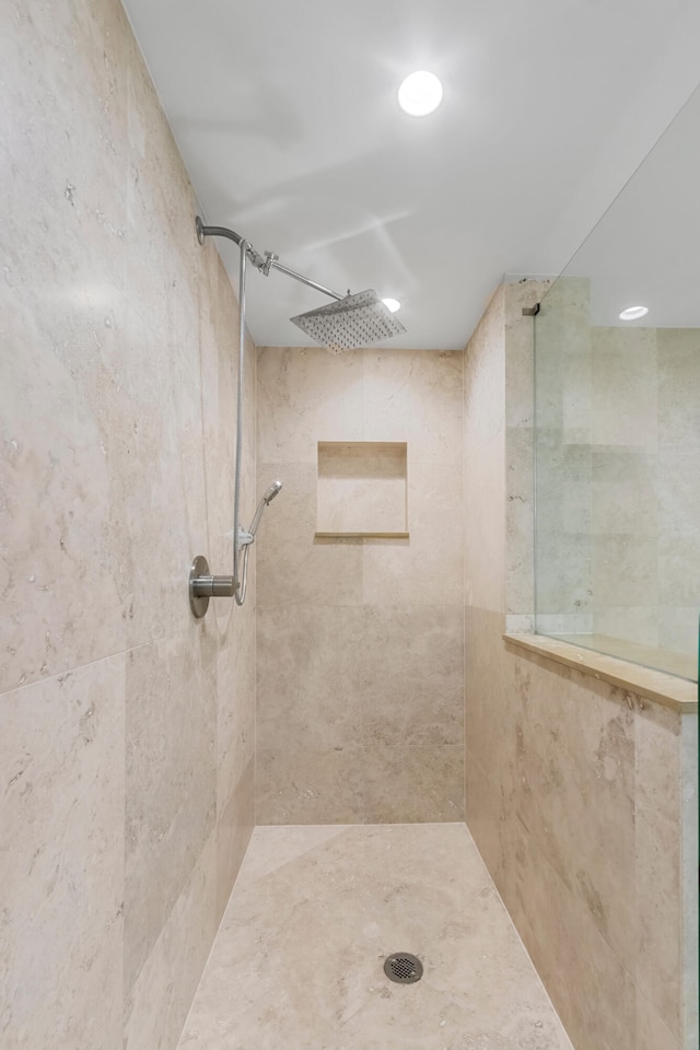 bathroom with a tile shower