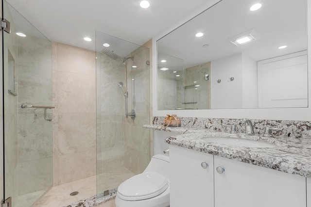 bathroom with vanity, toilet, and walk in shower