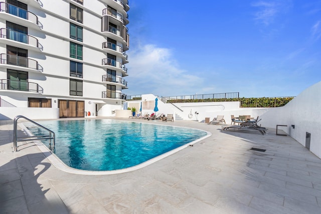 view of swimming pool featuring a patio area