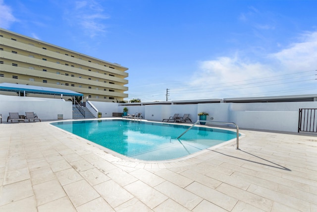 view of swimming pool featuring a patio area