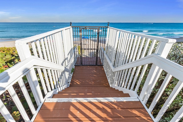 balcony with a water view and a beach view