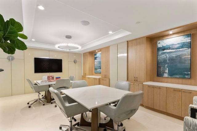 home office featuring light tile patterned floors and a tray ceiling