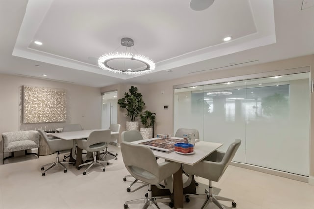 dining room with a raised ceiling