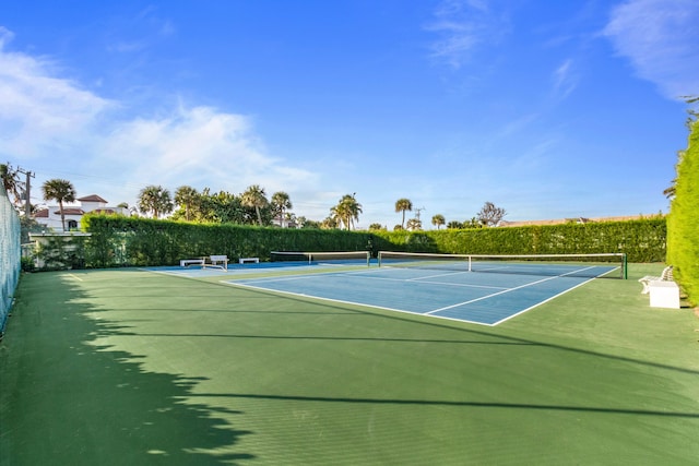 view of tennis court featuring basketball hoop