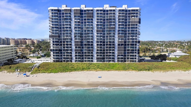 view of property featuring a beach view and a water view