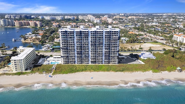 bird's eye view with a water view and a beach view