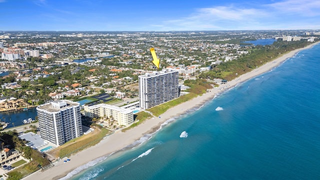 drone / aerial view featuring a water view and a beach view