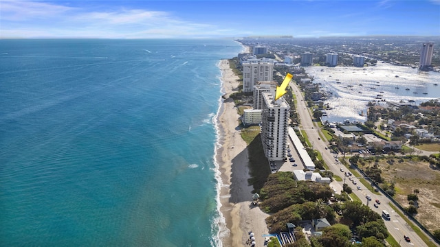 drone / aerial view featuring a water view and a beach view