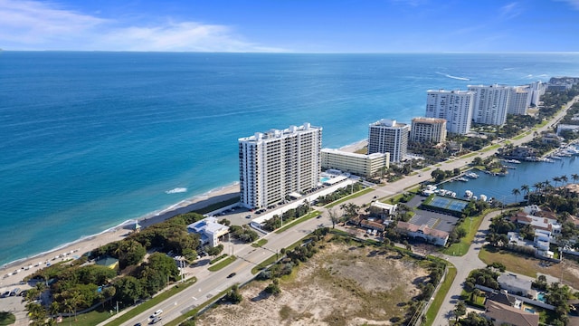 drone / aerial view featuring a water view and a beach view