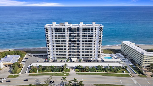 bird's eye view featuring a water view and a beach view