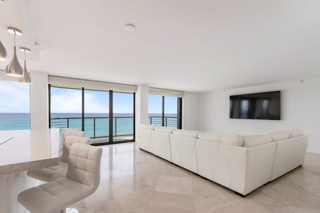 living room featuring a water view and floor to ceiling windows