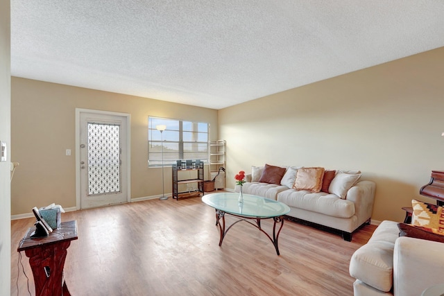 living room featuring a textured ceiling and light hardwood / wood-style flooring