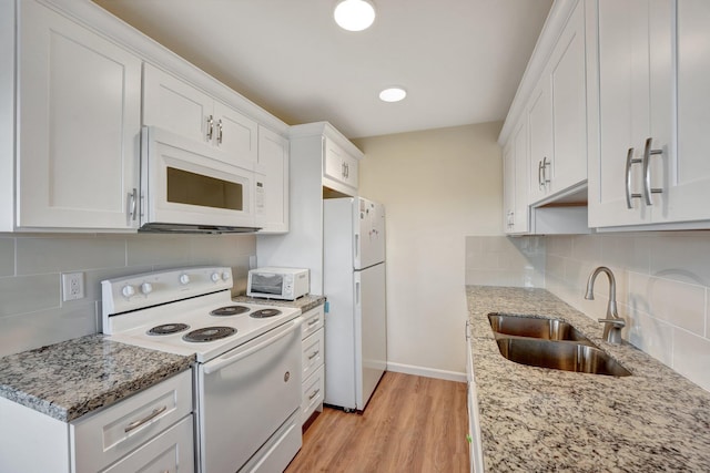 kitchen featuring light stone countertops, sink, light hardwood / wood-style flooring, white appliances, and white cabinets