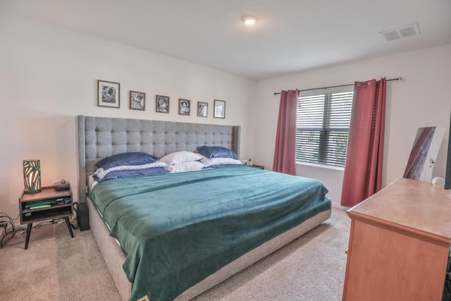 bedroom featuring light colored carpet