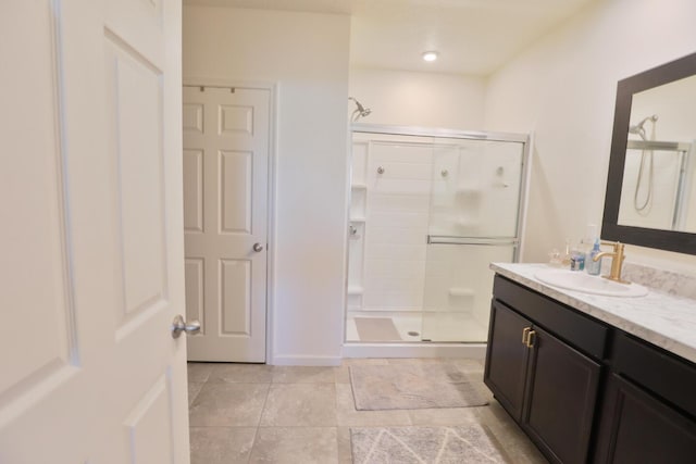 bathroom featuring vanity and an enclosed shower